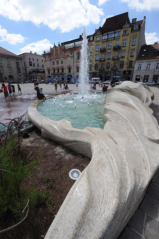 Ciekawa forma fontanny dobrze koresponduje z otaczającą plac secesyjną architekturą.